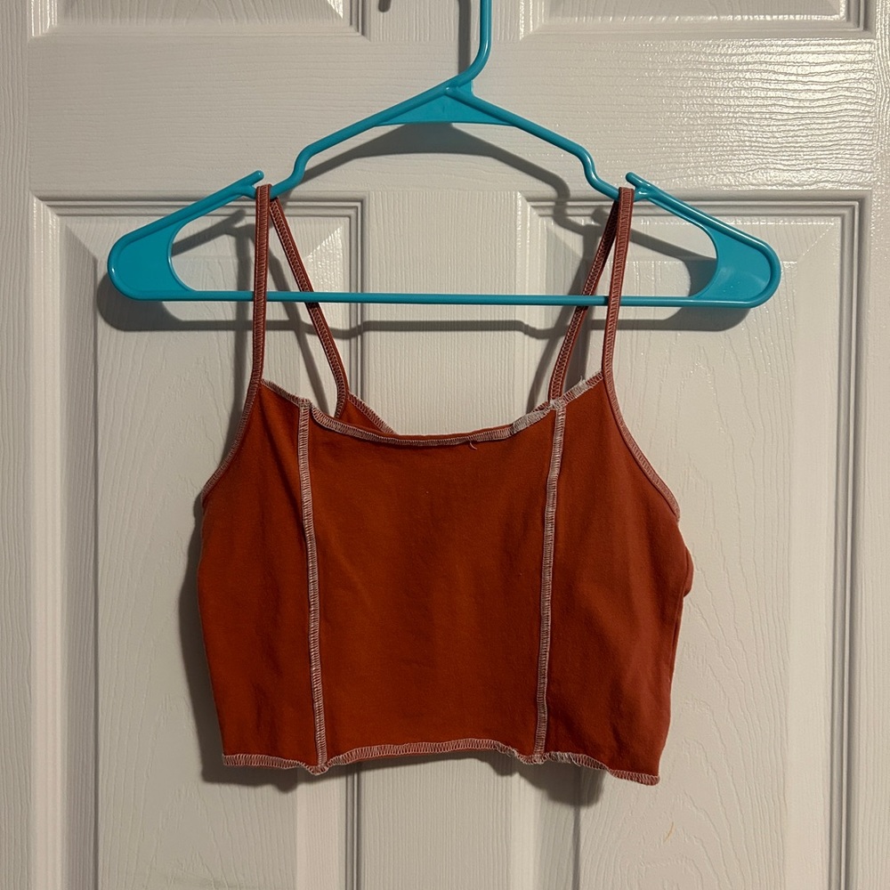 Pacsun red/orange colored top with white patchwork. Never worn. Size Medium.